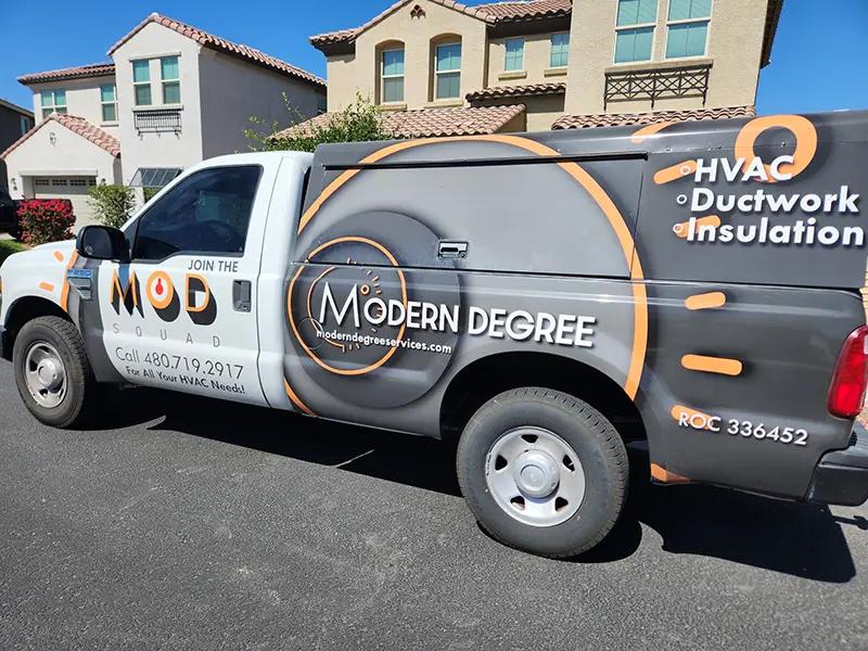 Modern Degree HVAC service truck with branded wrap showing HVAC, ductwork and insulation services parked in a residential neighborhood